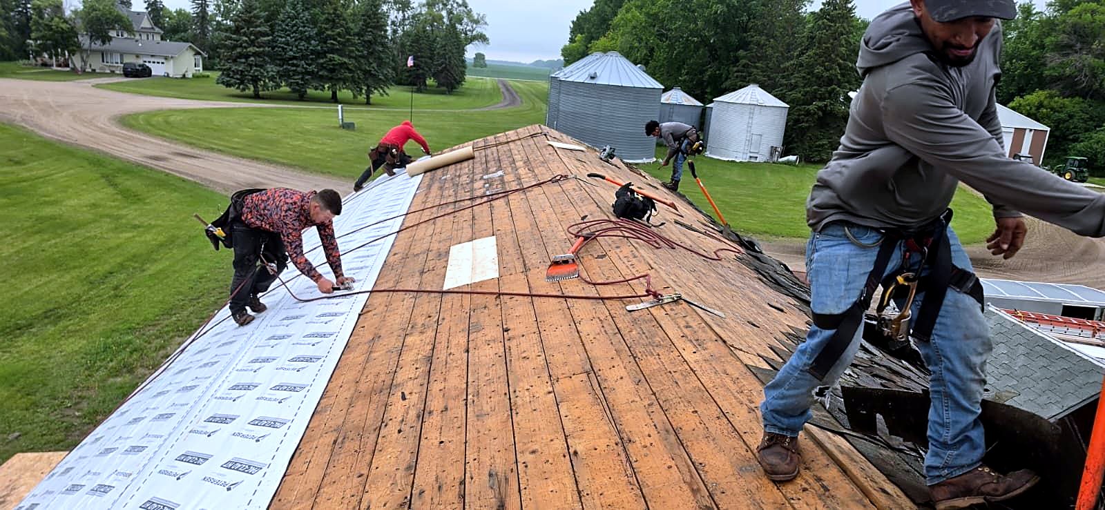 Maximum Roofing crew re-roofing a barn